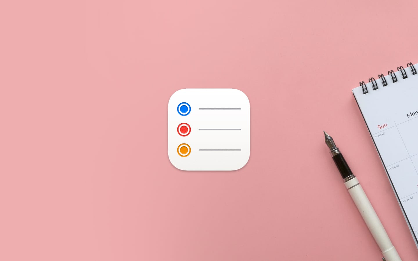 Apple Reminders icon overlaid on a surface with a pen and a calendar